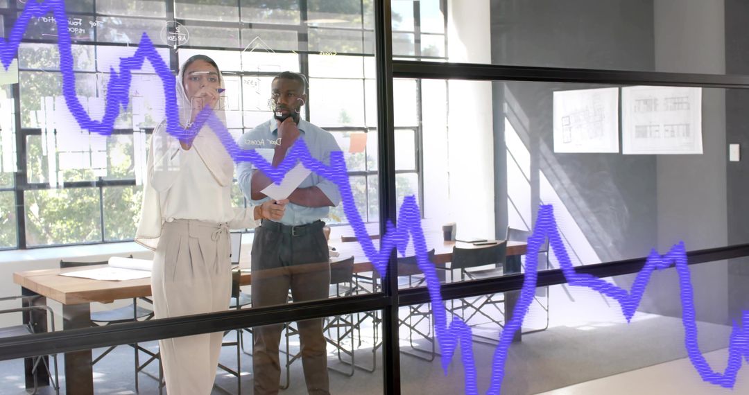 Colleagues Discussing Graph on Office Glass Board