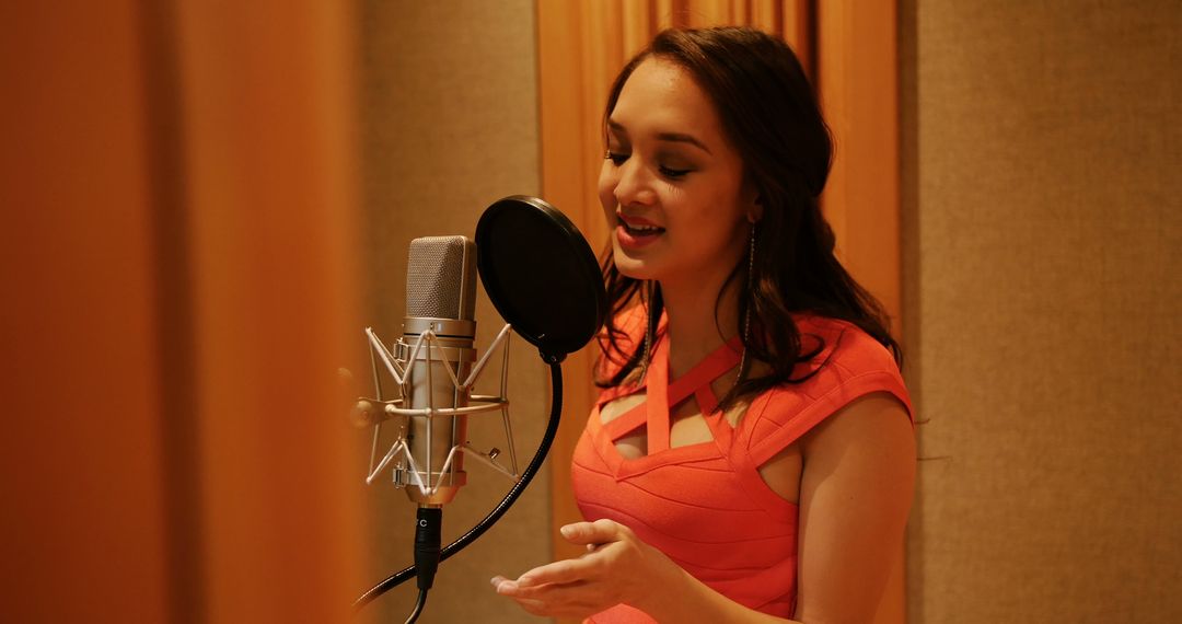 Female Singer in Recording Studio Singing into Microphone with Passion - Free Images, Stock Photos and Pictures on Pikwizard.com