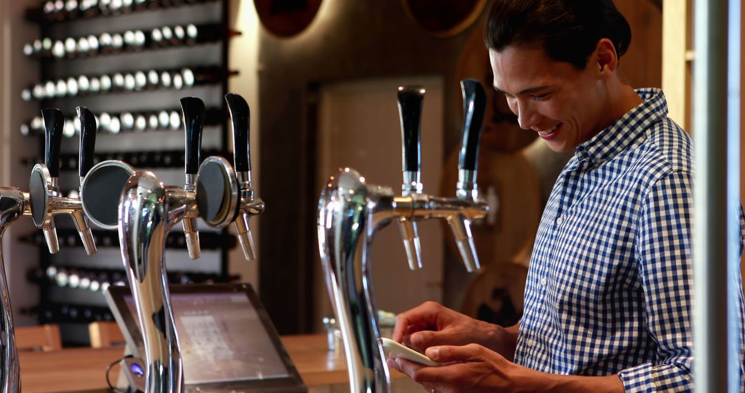 Young Man Enjoying Social Moment in Bar with Beer Taps