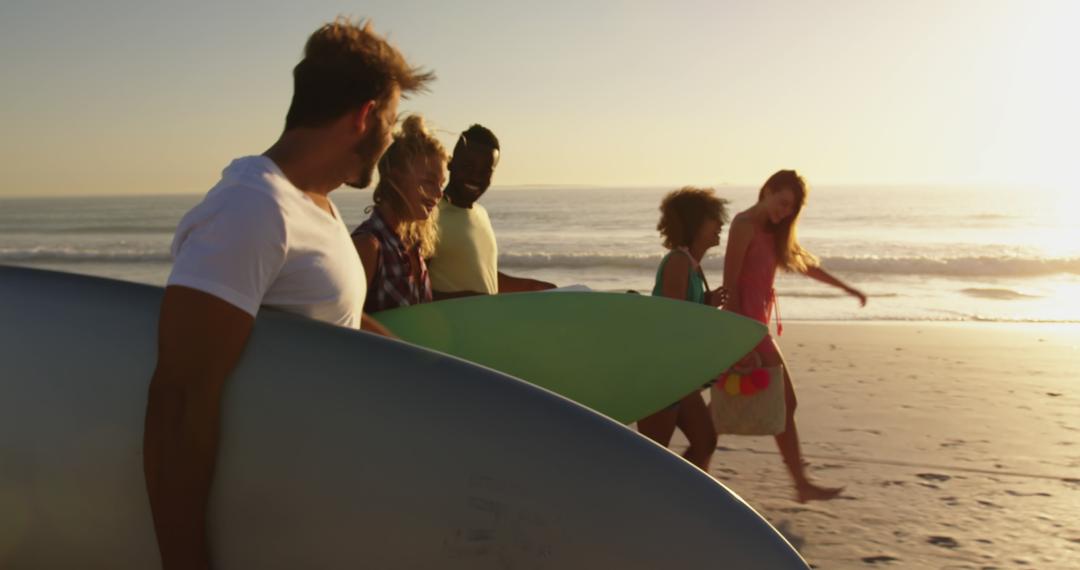 Group of Young Friends Walking on Beach with Surfboards at Sunset - Free Images, Stock Photos and Pictures on Pikwizard.com