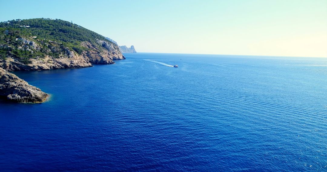 Serene Mediterranean Seascape with Clear Blue Waters and Rocky Coastline - Free Images, Stock Photos and Pictures on Pikwizard.com
