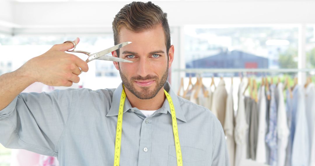 Confident Male Tailor Posing with Scissors in Tailor Shop - Free Images, Stock Photos and Pictures on Pikwizard.com