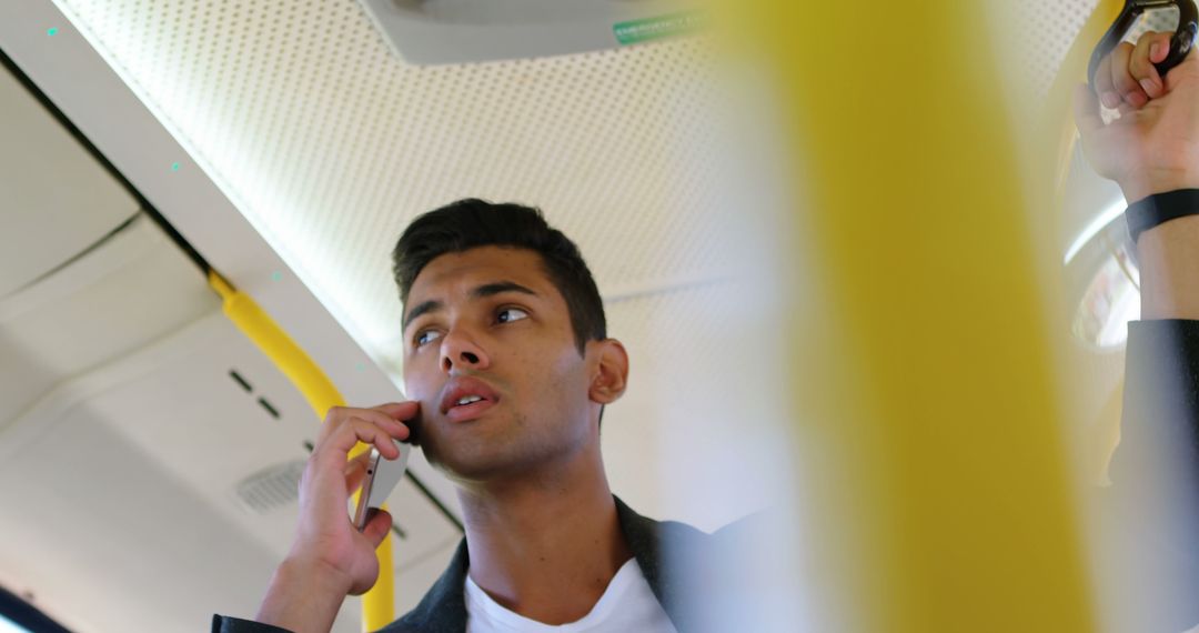 Young Man Talking on Phone in Public Transport - Free Images, Stock Photos and Pictures on Pikwizard.com