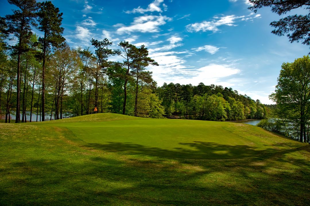 Scenic Golf Course with Lush Greenery and Lake View - Free Images, Stock Photos and Pictures on Pikwizard.com
