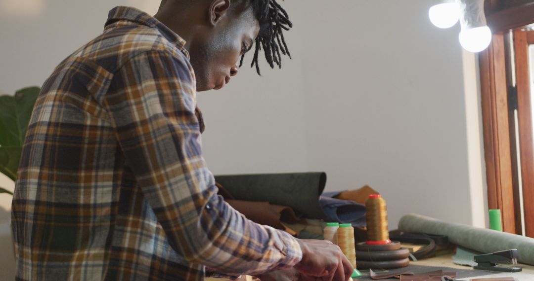 Focused Craftsman Skillfully Working in Leather Workshop