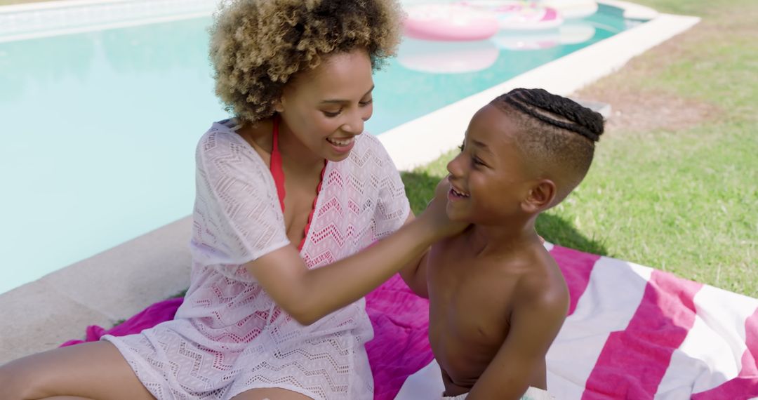 Joyful Mother and Son Relaxing by Backyard Pool