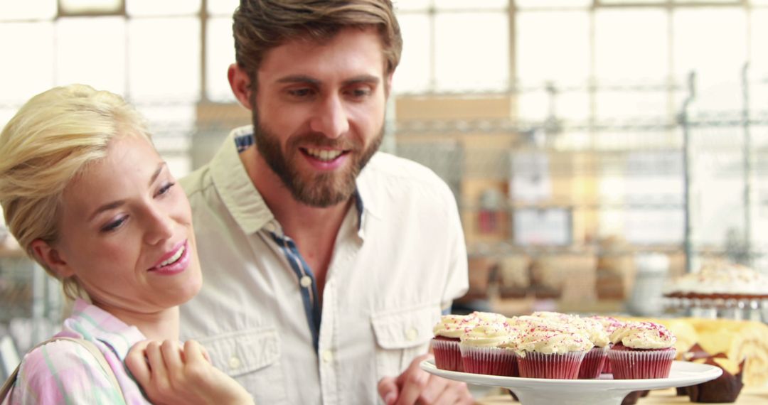 Couple Admiring Cupcakes in Bakery - Free Images, Stock Photos and Pictures on Pikwizard.com