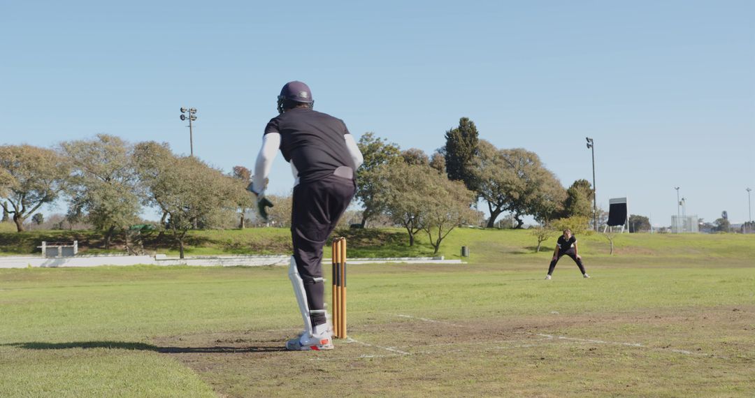 Cricketers Engaging in Intense Field Practice on Sunny Day