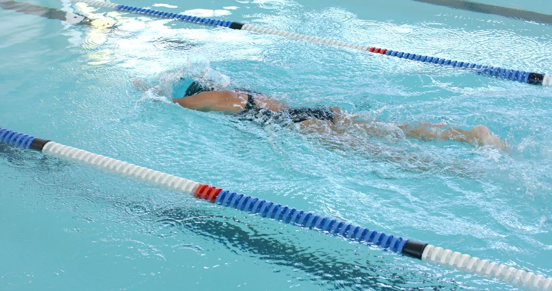 Professional Swimmer Competing in Pool Race