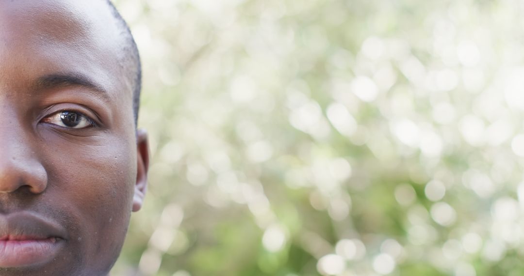 Thoughtful Expression of Man Against Blurred Natural Background
