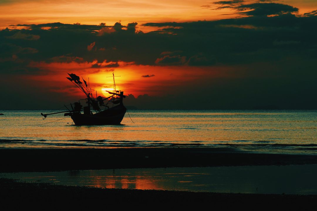 Silhouette of a Fishing Boat at Sunset on Calm Sea - Free Images, Stock Photos and Pictures on Pikwizard.com