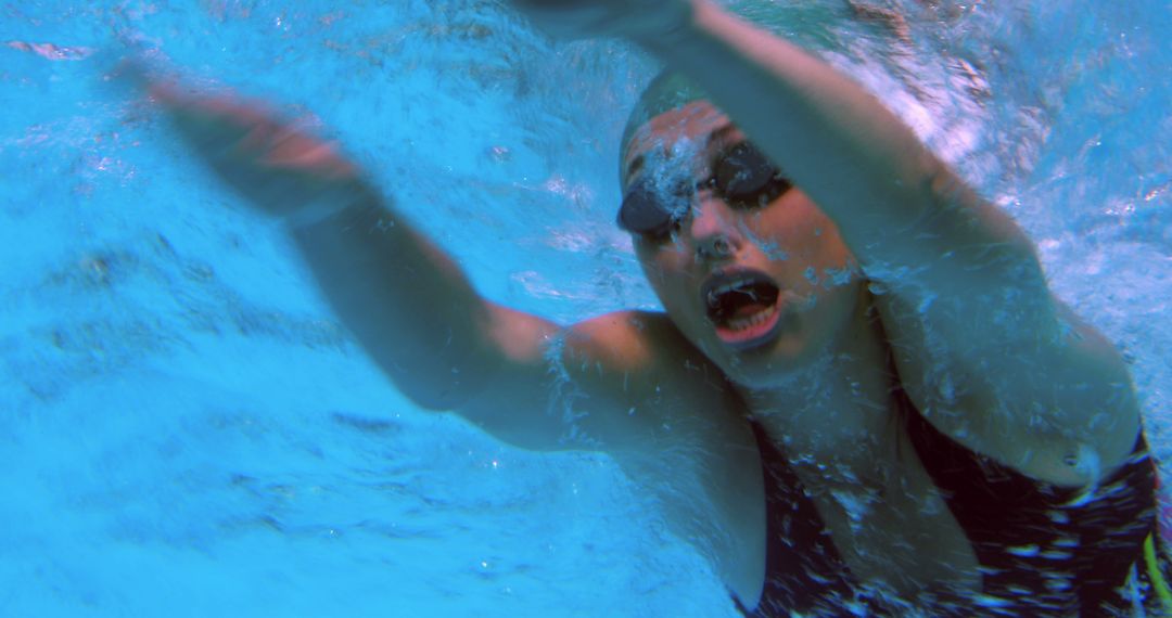 Female Swimmer Performing Freestyle Stroke Underwater - Free Images, Stock Photos and Pictures on Pikwizard.com