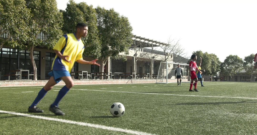 Dynamic Soccer Players Practicing on Sunny Green Field