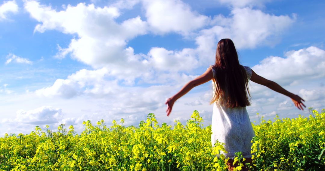 Woman Enjoying Blooming Field on Sunny Day - Free Images, Stock Photos and Pictures on Pikwizard.com