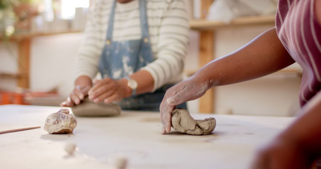 People Shaping Clay on Worktable in Pottery Workshop - Free Images, Stock Photos and Pictures on Pikwizard.com