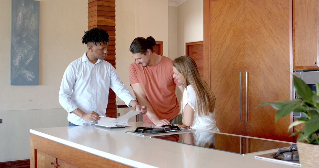 Consulting in Modern Kitchen with Diverse Group Discussing Plans