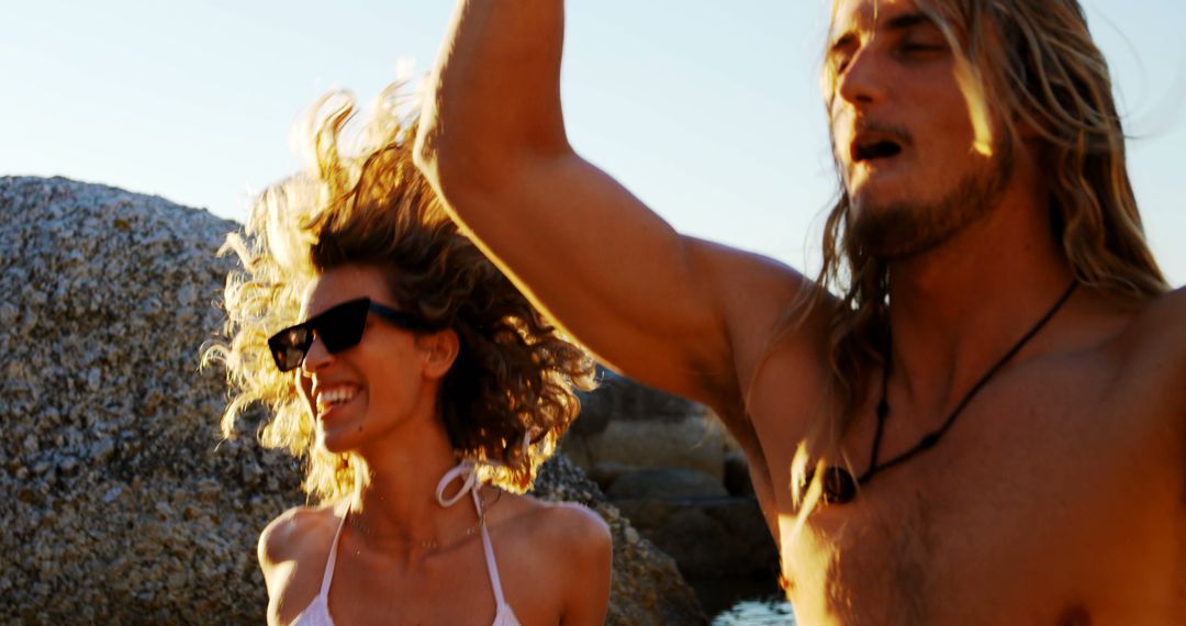 Couple Enjoying Beach Party, Dancing in Sunshine - Free Images, Stock Photos and Pictures on Pikwizard.com