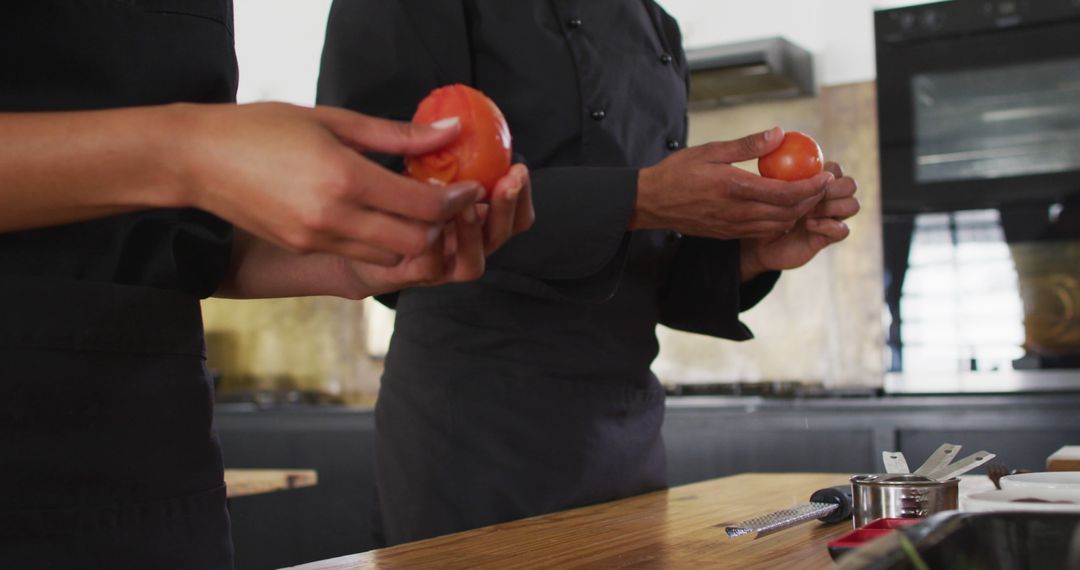 Chefs Holding Fresh Tomatoes in Professional Kitchen - Free Images, Stock Photos and Pictures on Pikwizard.com