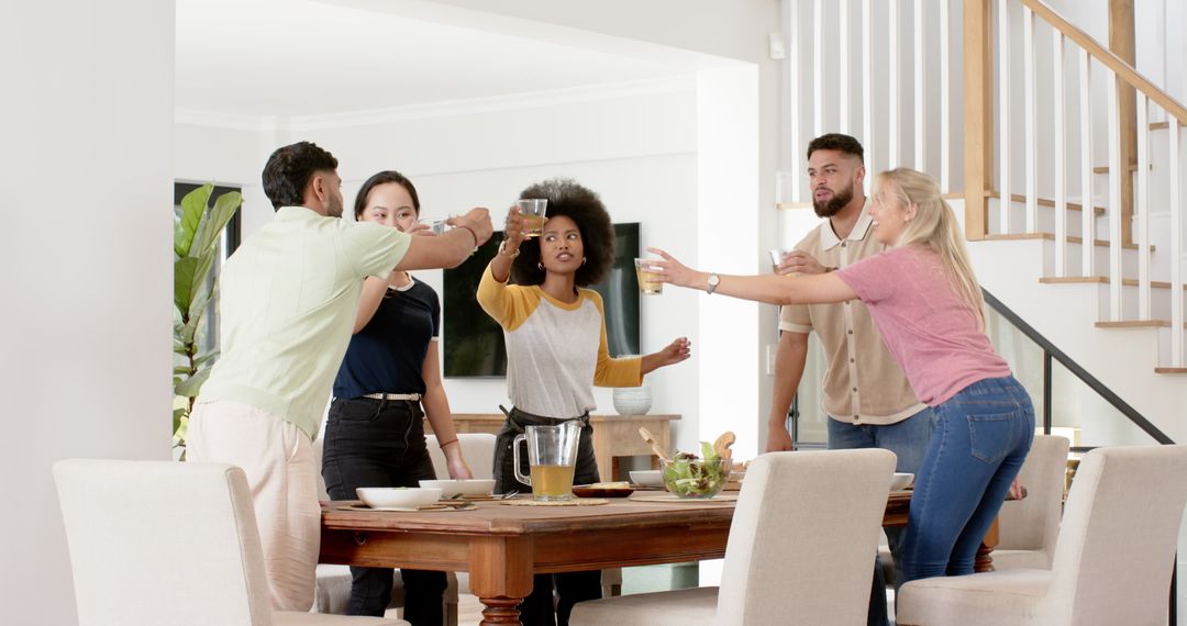 Diverse Friends Socializing Around Dining Table at Home