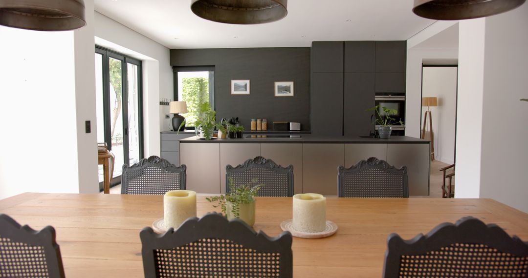 Modern Kitchen with Dark Cabinetry and Wooden Dining Table