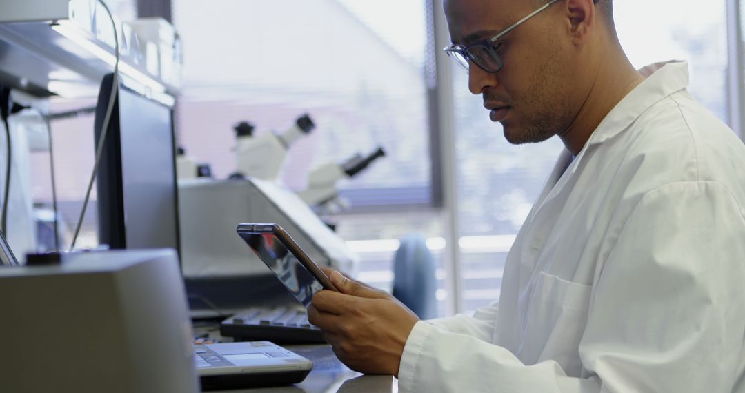 Scientist Analyzing Data on Tablet in Laboratory - Free Images, Stock Photos and Pictures on Pikwizard.com