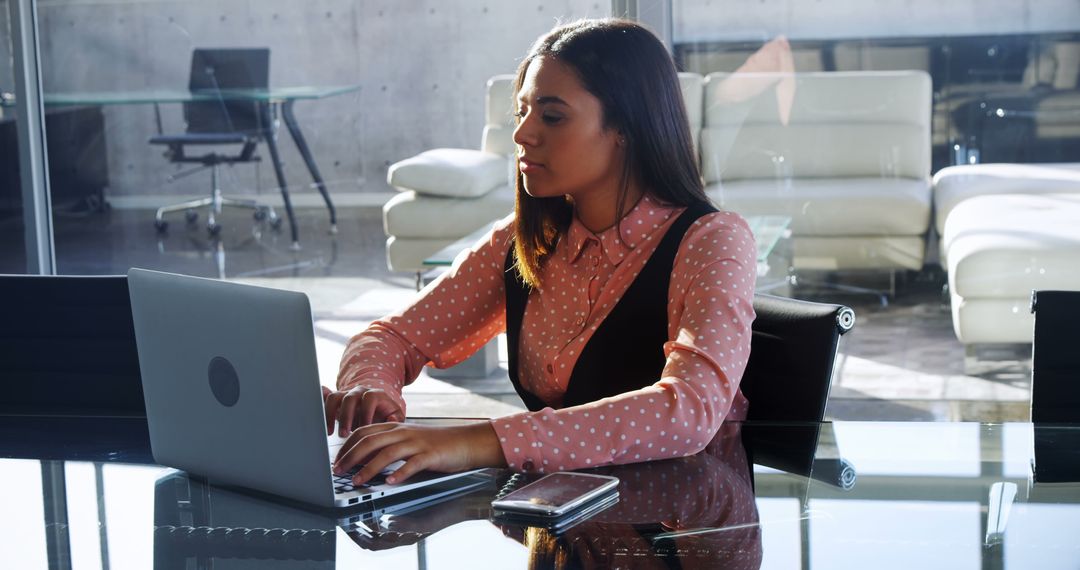 Professional Woman Typing on Laptop in Modern Office - Free Images, Stock Photos and Pictures on Pikwizard.com