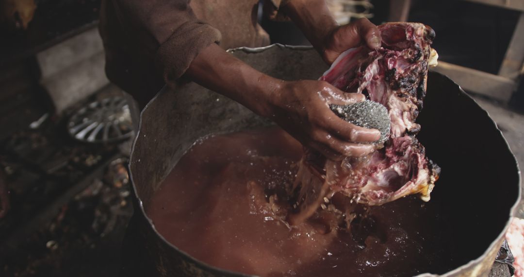 Close-up of Person Cleaning Meat in Rusty Container - Free Images, Stock Photos and Pictures on Pikwizard.com