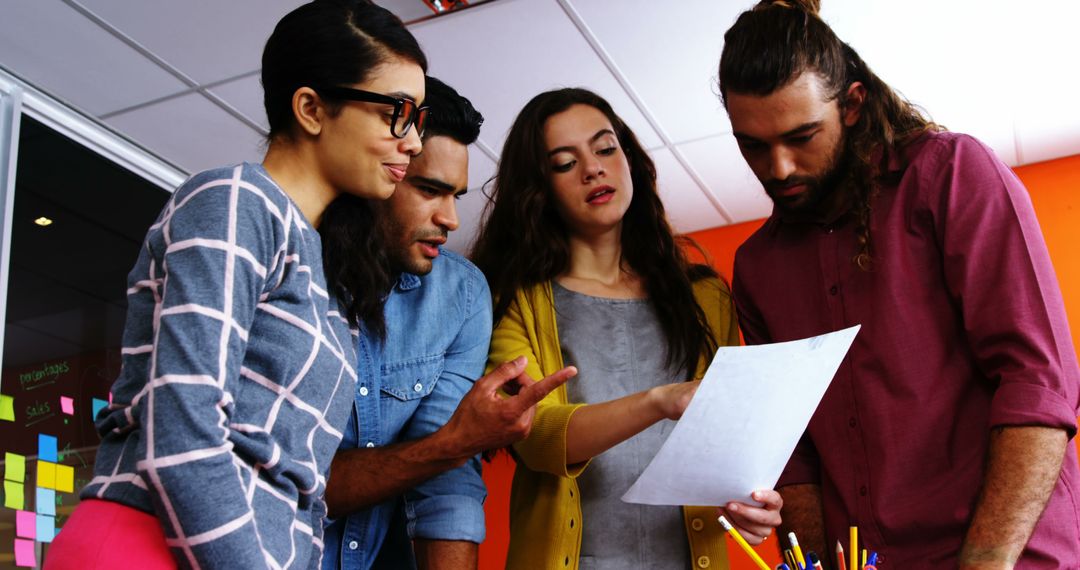 Creative Team Collaborating on Project in Colorful Office Environment