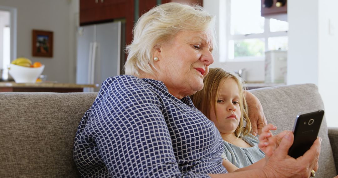 Grandmother and Granddaughter Exploring Smartphone Together - Free Images, Stock Photos and Pictures on Pikwizard.com