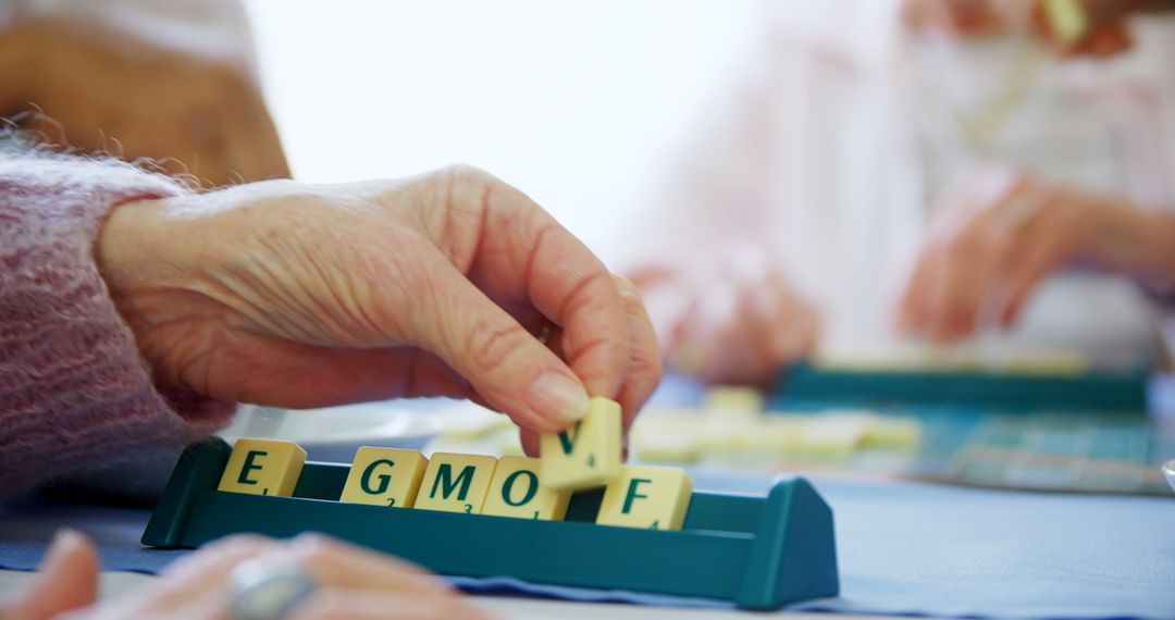 Seniors Playing Scrabble Word Game in Nursing Home
