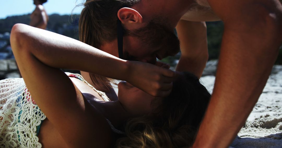 A young Caucasian couple shares an intimate moment on the beach, with copy space - Free Images, Stock Photos and Pictures on Pikwizard.com