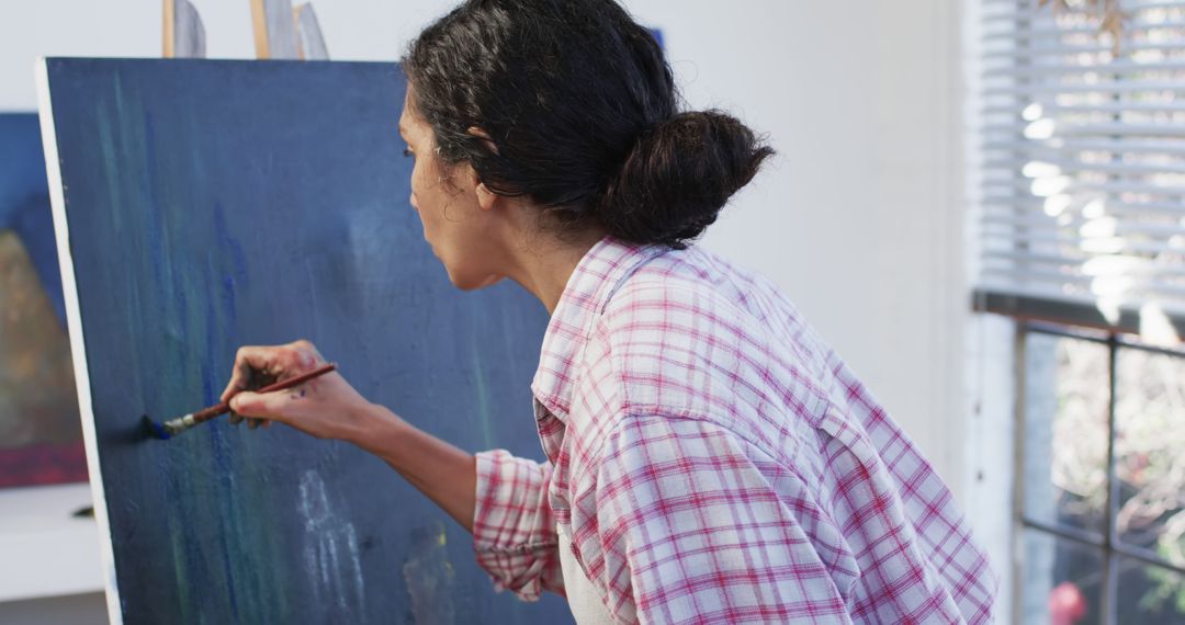 Focused Artist Woman Painting on Canvas in Studio - Free Images, Stock Photos and Pictures on Pikwizard.com