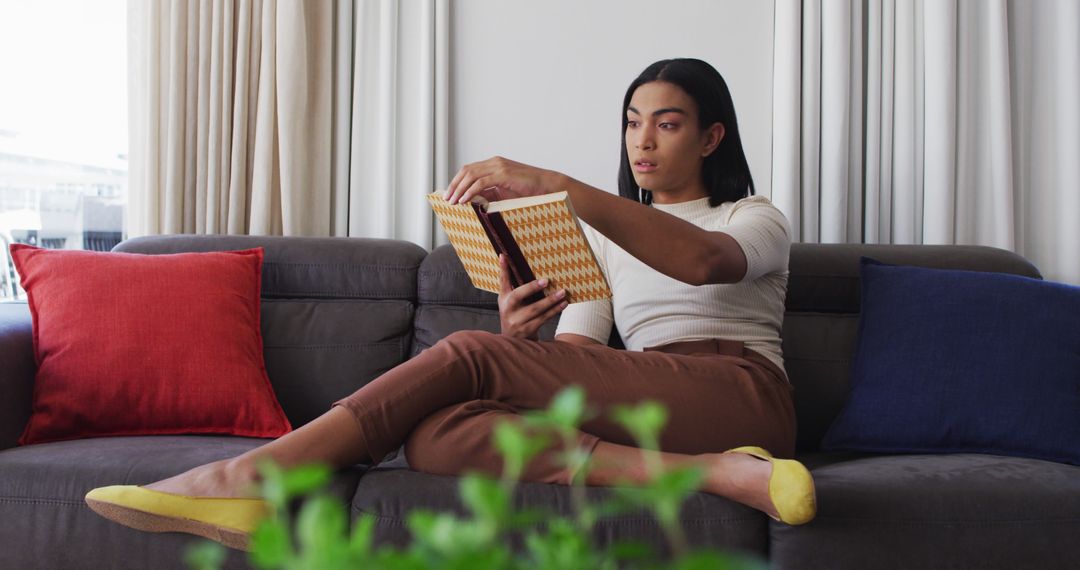 Woman Reading Book on Modern Sofa in Cozy Living Room - Free Images, Stock Photos and Pictures on Pikwizard.com