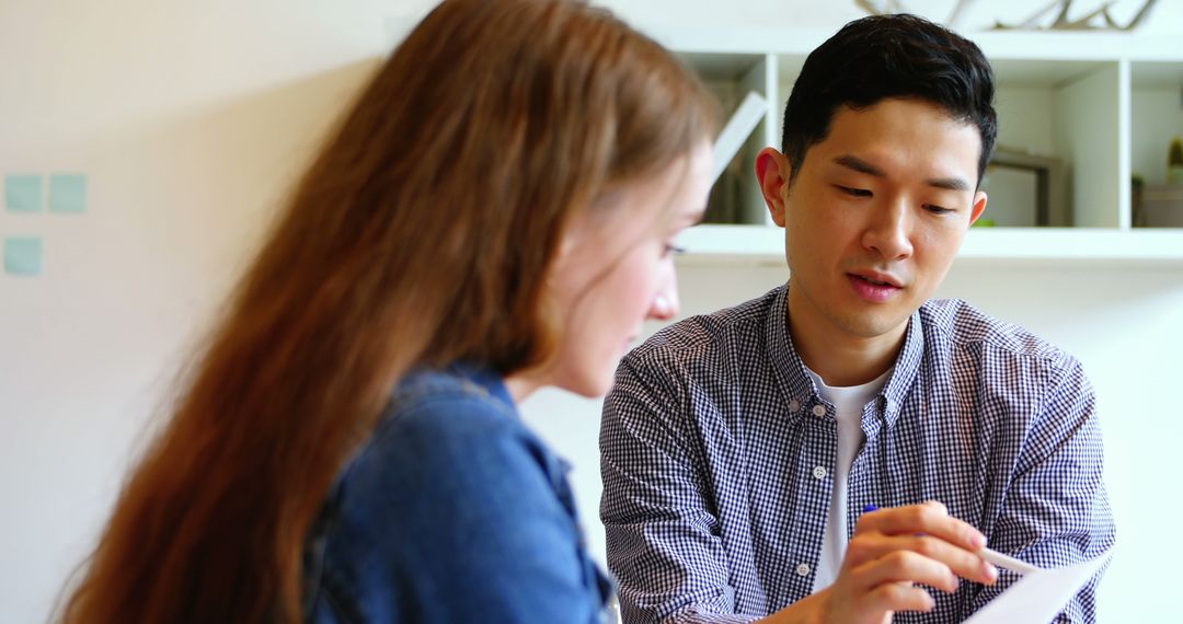 Business Executives Analyzing Documents in Office Environment