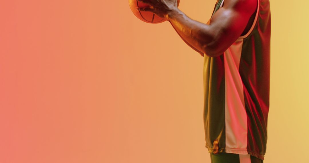 Athlete Holding Basketball Ready for Game on Colorful Gradient Background - Free Images, Stock Photos and Pictures on Pikwizard.com