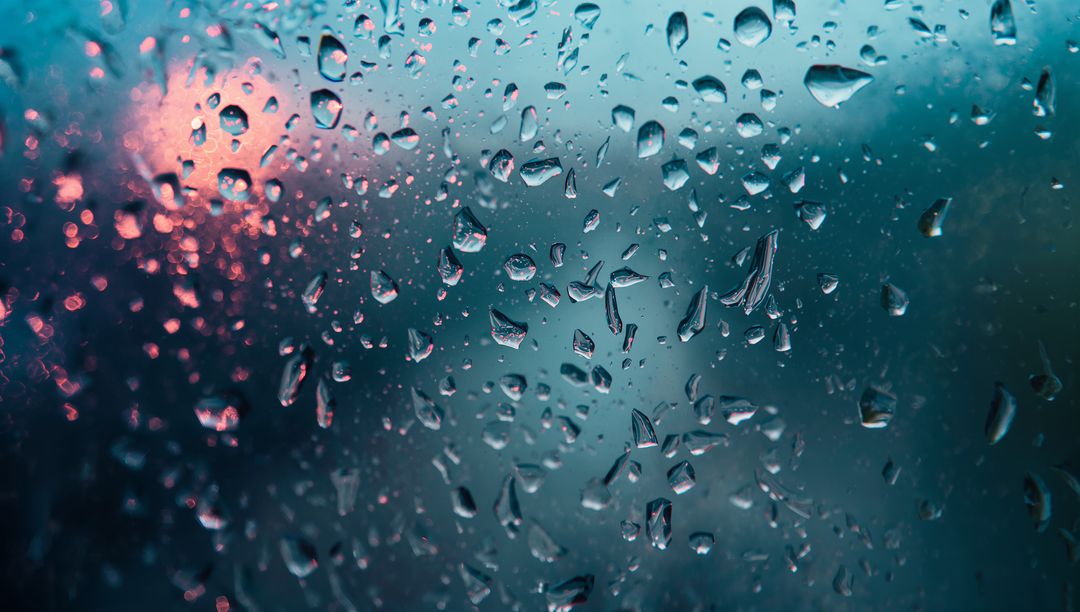 Raindrops on Window with Blurred Evening City Lights