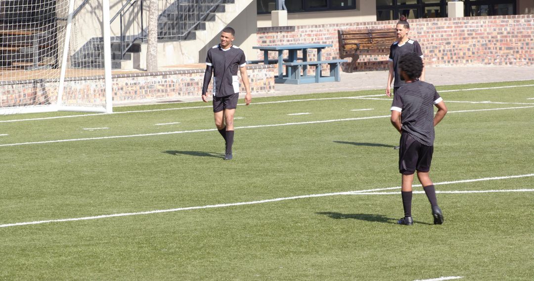 Soccer Players on Field Focused on Teamwork and Strategy