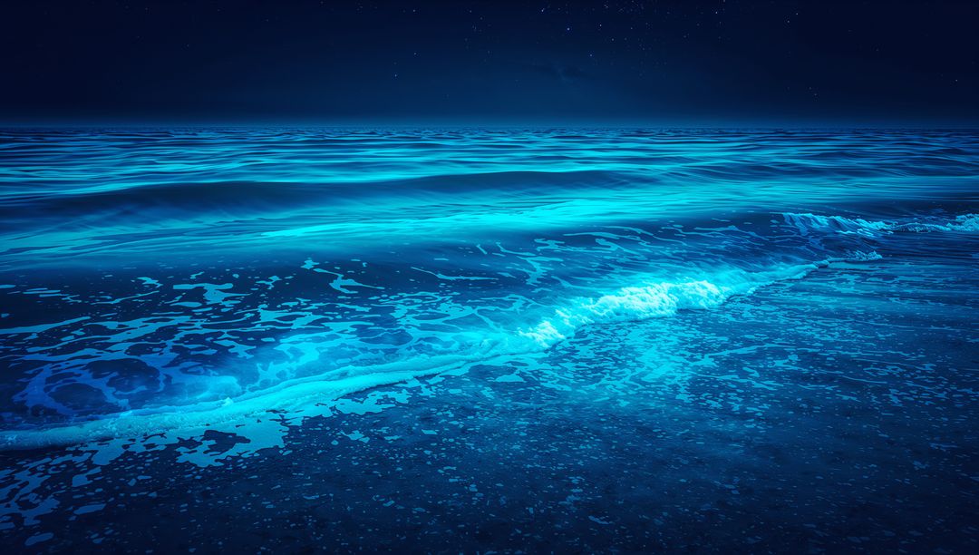 Glowing Bioluminescent Ocean Shore at Night Lighting Cyan Waves and Foamy Wet Sand