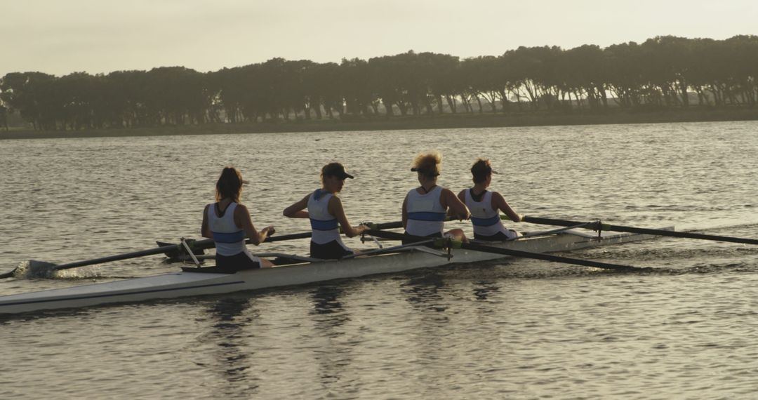 Women Rowing Team Training During Sunset on Tranquil Water - Free Images, Stock Photos and Pictures on Pikwizard.com