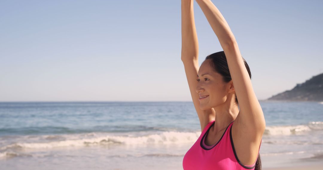 Woman Smiling While Stretching on Beach - Free Images, Stock Photos and Pictures on Pikwizard.com