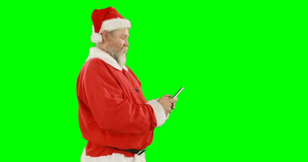 Santa Claus using smartphone against green screen - Free Images, Stock Photos and Pictures on Pikwizard.com