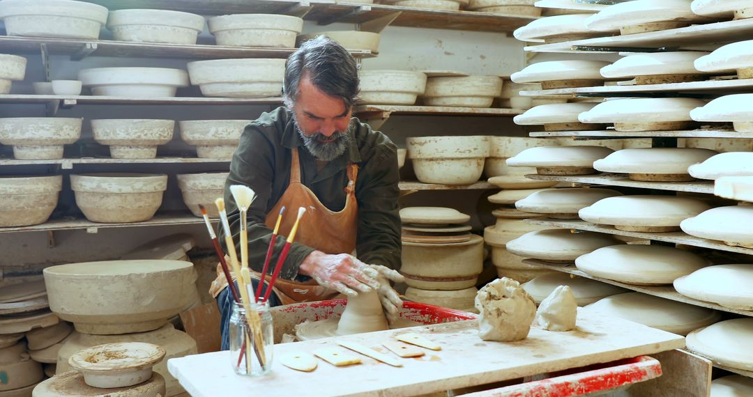 Skilled Potter Working with Clay in Ceramics Workshop - Free Images, Stock Photos and Pictures on Pikwizard.com