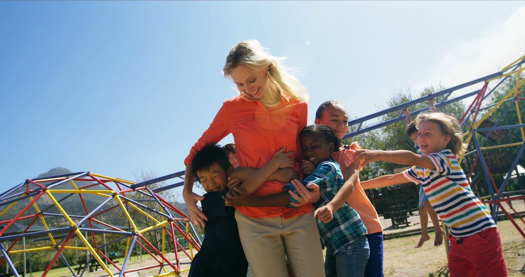 Teacher and Children Hugging and Playing in Playground - Free Images, Stock Photos and Pictures on Pikwizard.com