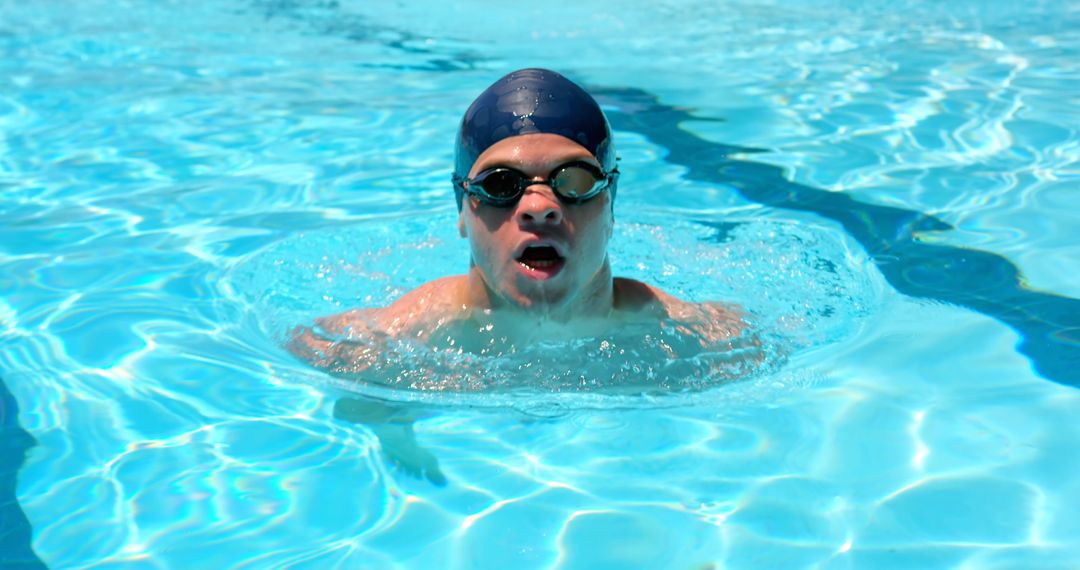 Male Swimmer Practicing in Sunlit Pool - Free Images, Stock Photos and Pictures on Pikwizard.com