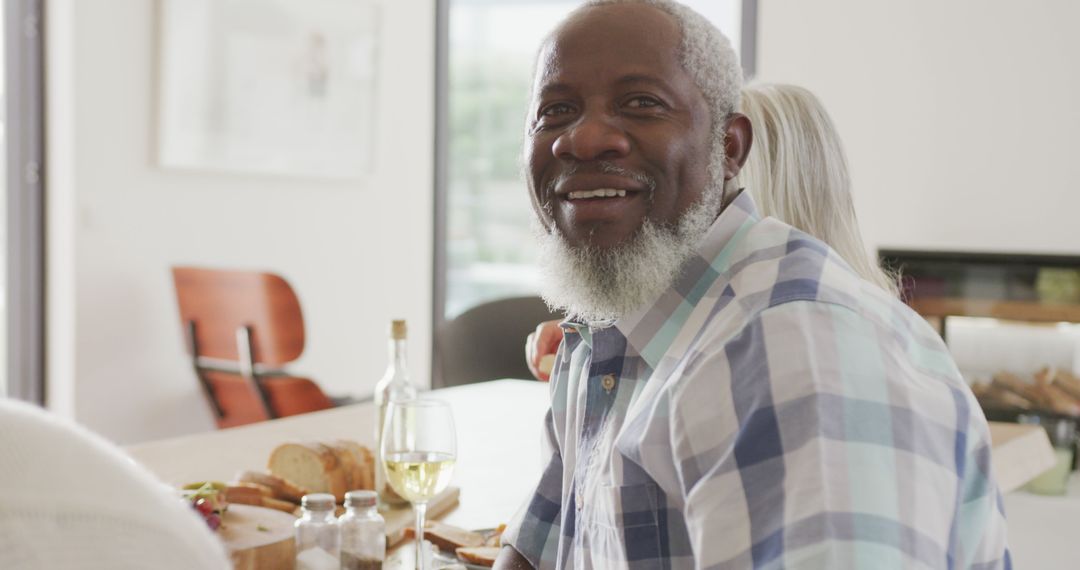 Smiling Elderly Man Enjoying Meal at Home - Free Images, Stock Photos and Pictures on Pikwizard.com