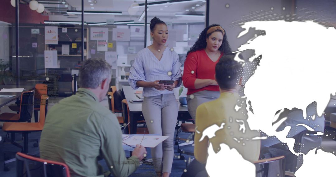 Two women leading team meeting in modern open office with world map overlay and strategy briefing