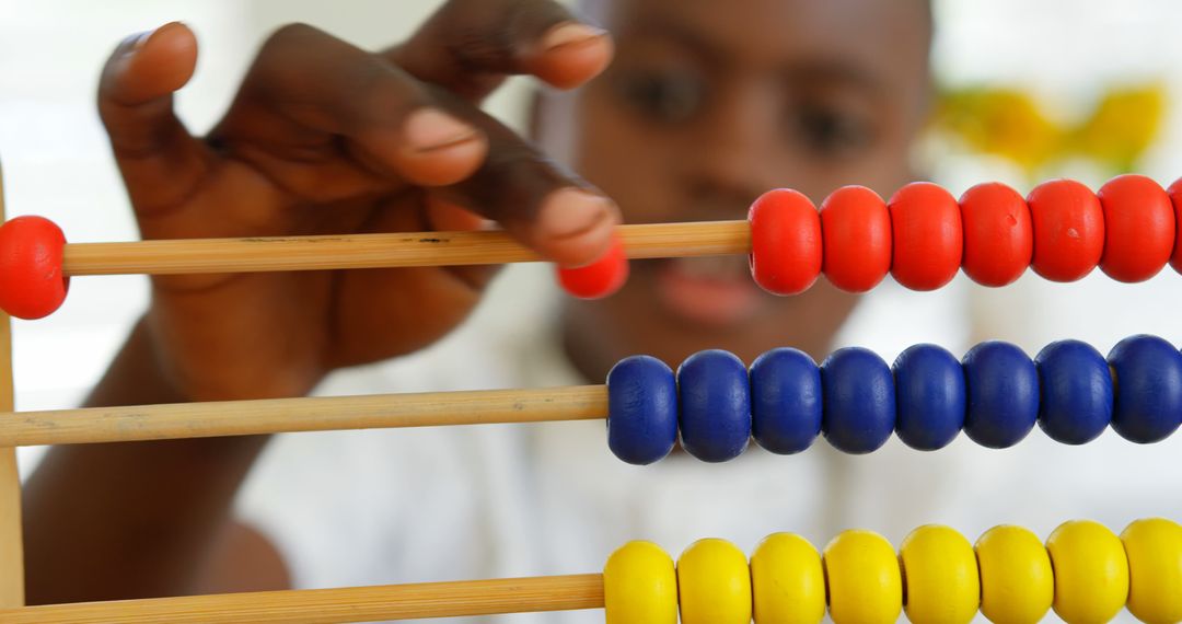 Child Counting with Colorful Abacus - Free Images, Stock Photos and Pictures on Pikwizard.com