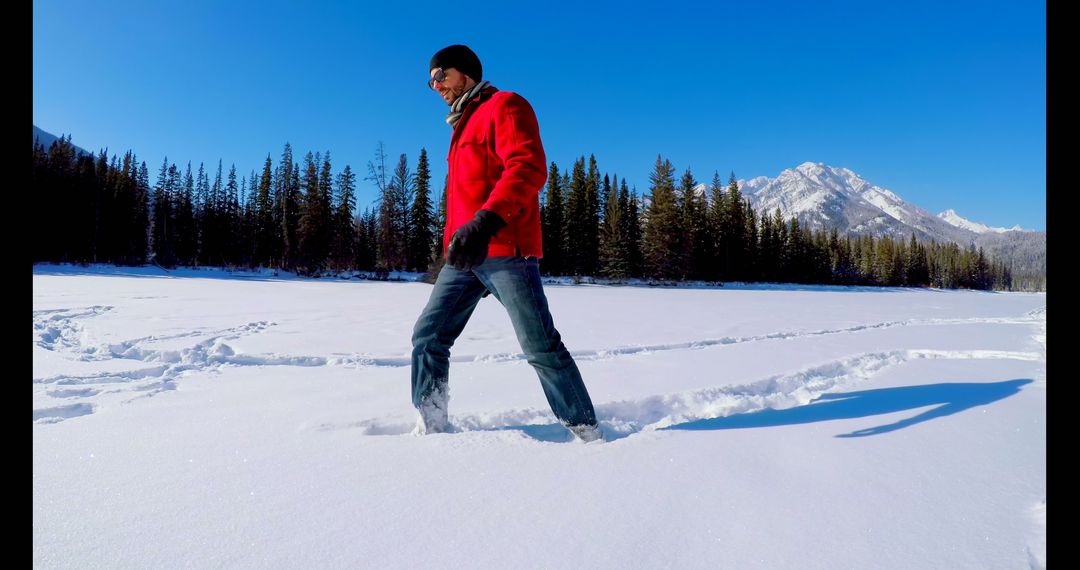 Man Walking on Snowy Landscape in Winter Mountain Forest - Free Images, Stock Photos and Pictures on Pikwizard.com