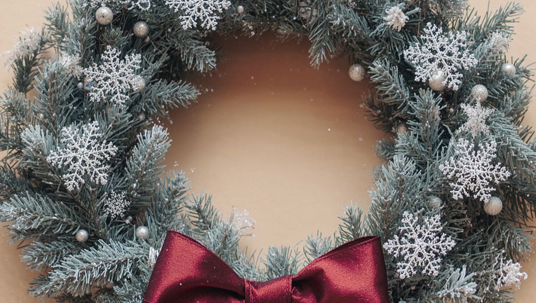 Frosted Pine Wreath Featuring Snowflake Ornaments and Burgundy Bow