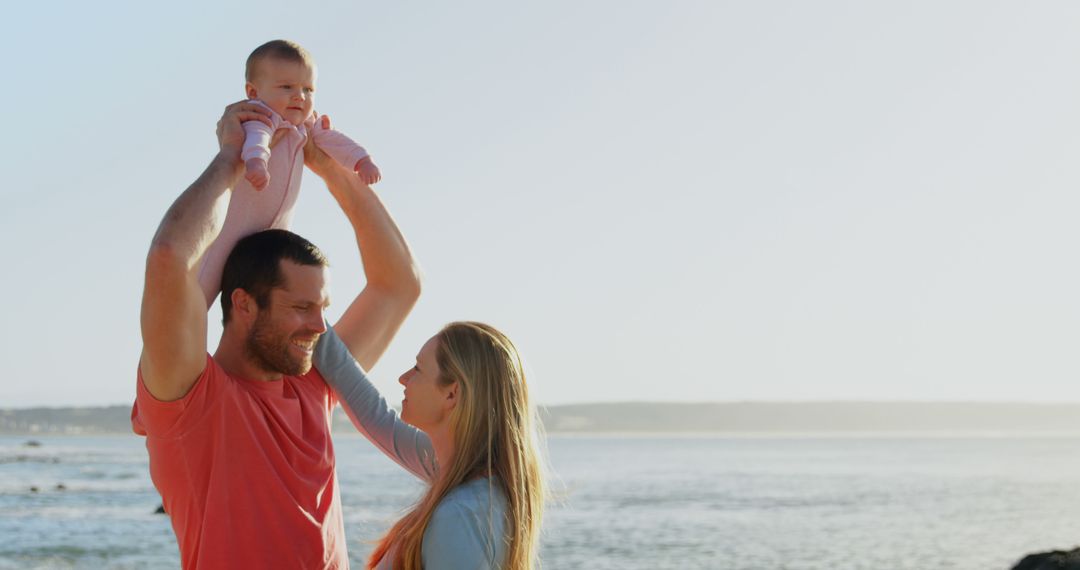 Happy Family Enjoying Sunny Day by the Ocean